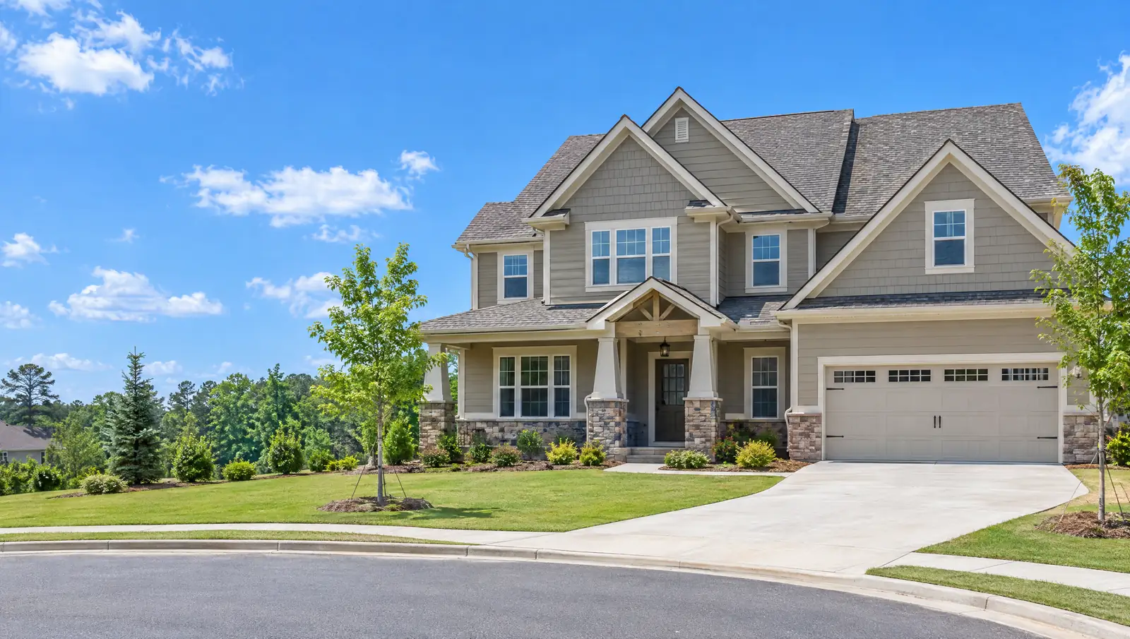 Suburban Georgia home with a new architectural shingle roof under a blue sky